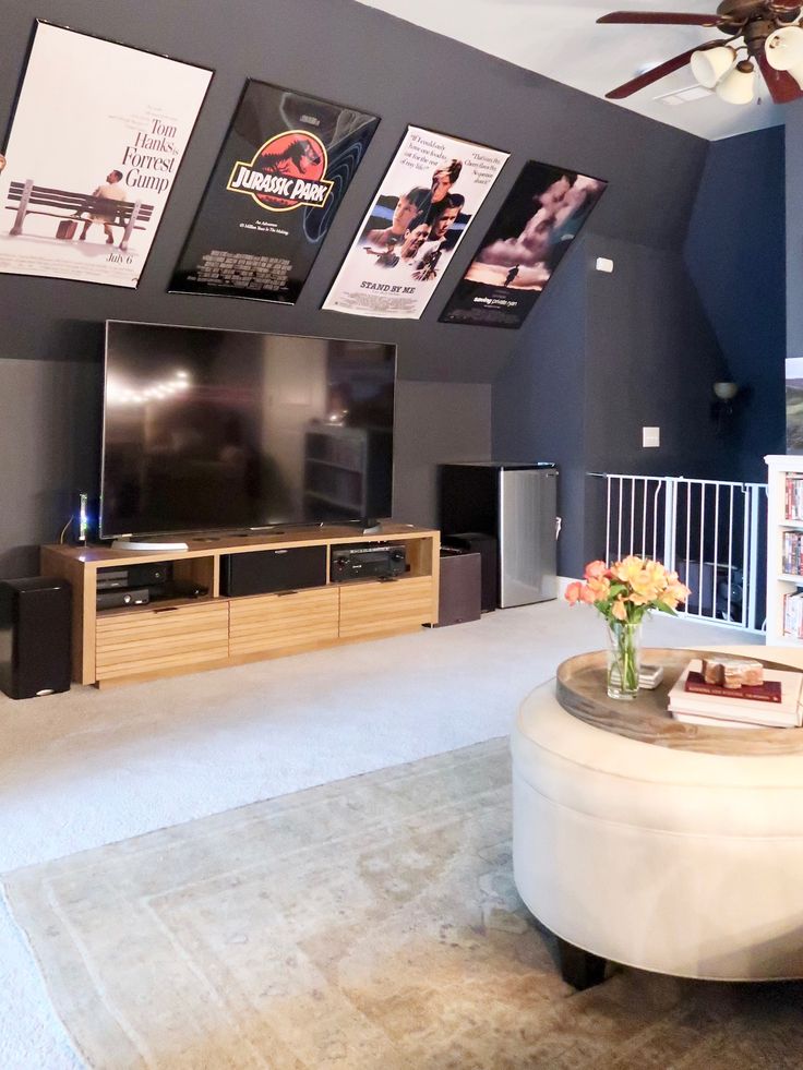 a living room filled with furniture and a flat screen tv on top of a wall