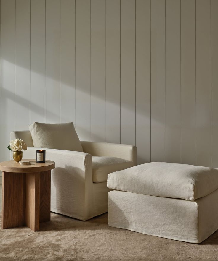 a white chair and ottoman in a room