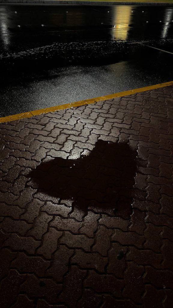 a heart shaped hole in the ground on a rainy night