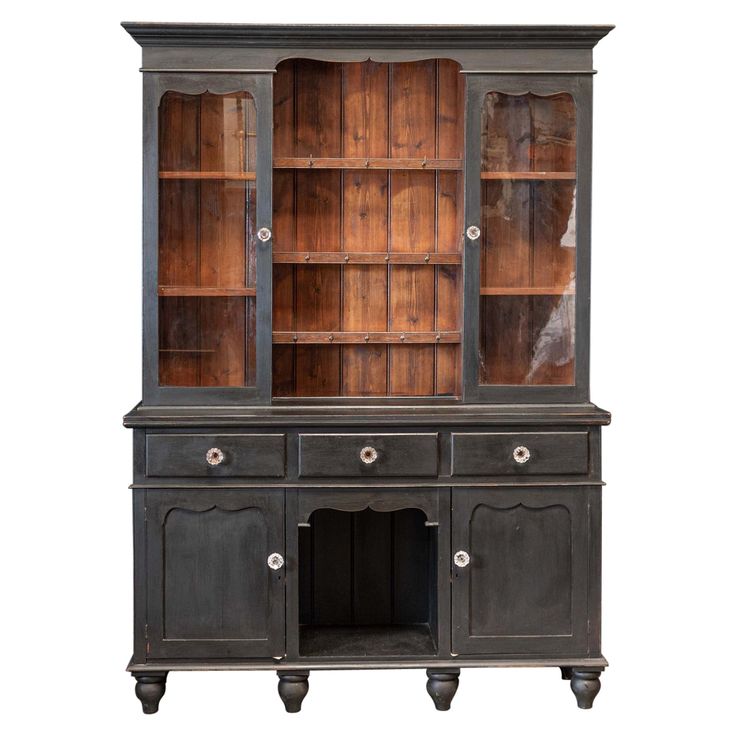 an old black china cabinet with glass doors and drawers on the front, against a white background