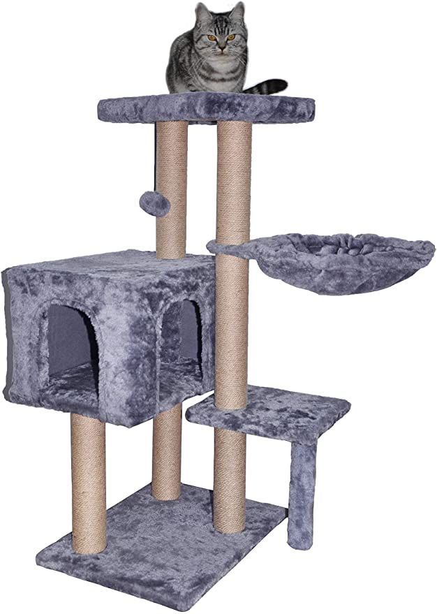 a cat sitting on top of a scratching tower