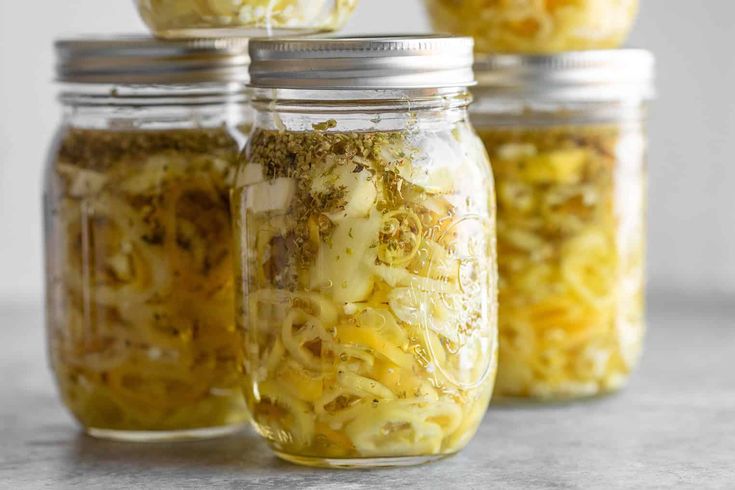 three jars filled with food sitting on top of a table