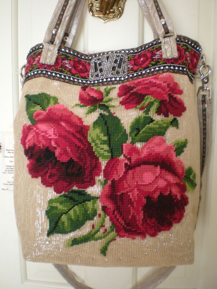 a handbag hanging on a door handle with flowers painted on the front and sides