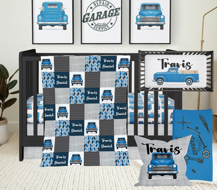 a baby crib bedding set with blue trucks and cars on it, next to two framed pictures