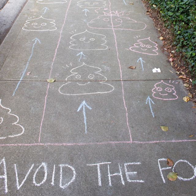 chalk drawings on the sidewalk that say avoid the fox and have arrows drawn in them