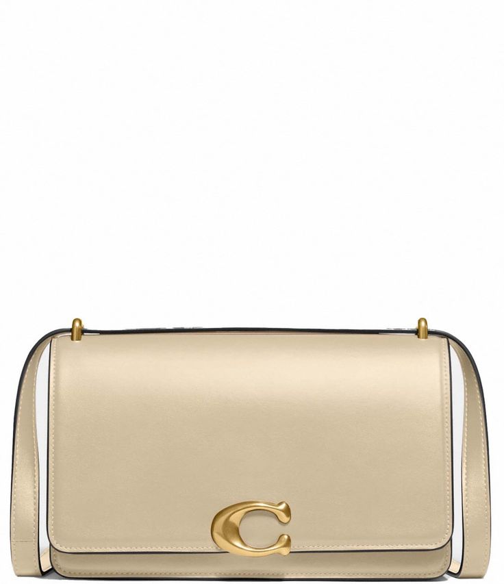 From COACH, the Bandit Leather Shoulder Crossbody Bag features: Luxe refined calf leatherSnap closureLeather liningInside snap and multifunction pockets Outside open pocketAdjustable shoulder strap for shoulder or crossbody wearApprox. 9.25" L x 5.75" H x 2.25" W bag; 21.5" strap drop Imported. Elegant Gold Crossbody Flap Bag, Elegant Gold Calf Leather Bags, Gold Shoulder Bag With Cc Turnlock Closure For Evening, Gold Shoulder Bag With Cc Turnlock For Evening, Gold Leather Flap Bag For Evening, Chic Gold Calf Leather Shoulder Bag, Gold Formal Flap Bag With Cc Turnlock Closure, Gold Calf Leather Bag For Formal Occasions, Formal Gold Calf Leather Bag