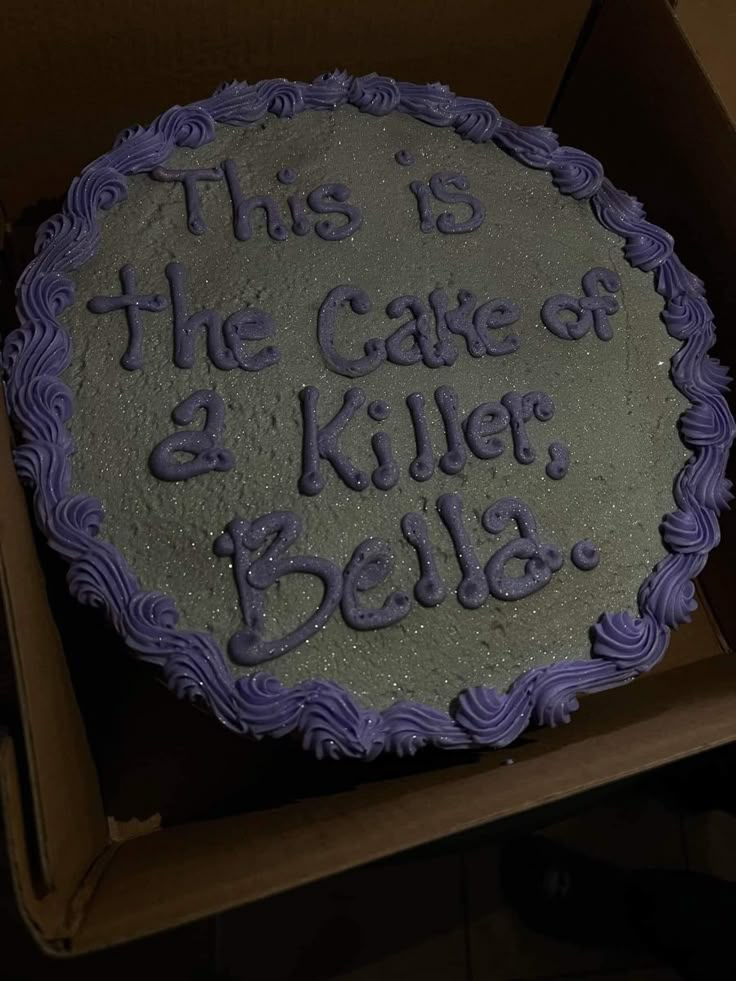 A gray cake with silver sparkles in the icing. In purple frosting, the cake reads, “this is the cake of a killer, Bella.” Twilight Theme Cake, Twilight Desserts, How Long Have You Been 17 Twilight Cake, Twilight Food Ideas, Funny Birthday Cakes For Teens, Twilight Party Food, Twilight Cake Ideas, Twilight Themed Food, Twilight Themed Snacks