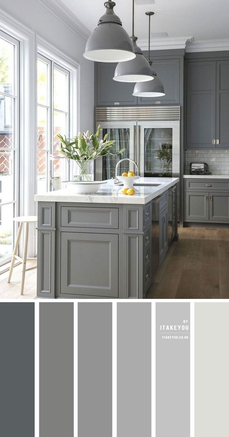 a kitchen with gray cabinets and white counter tops, along with an island in the middle