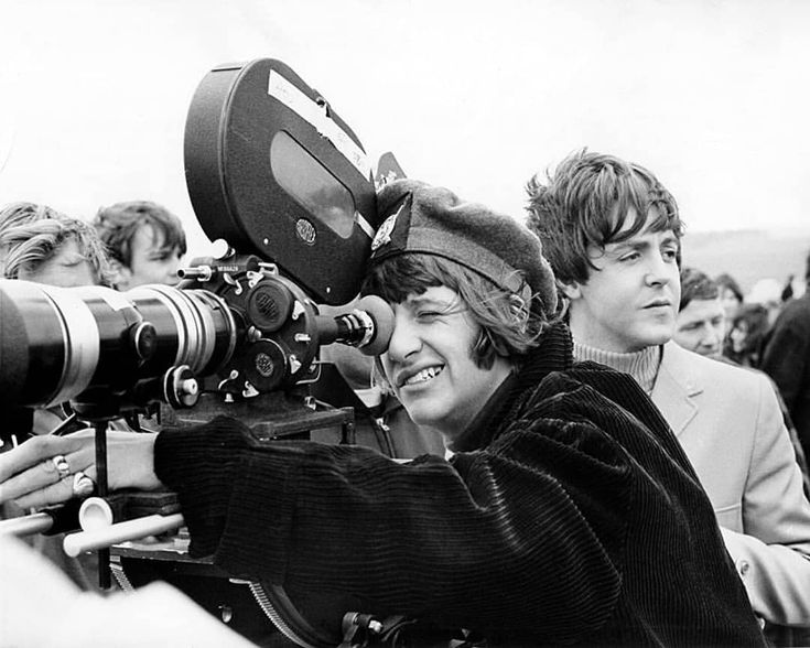 black and white photograph of two people with cameraman's equipment in front of them