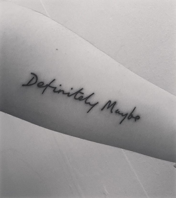 a black and white photo of a person's arm with the words definitely maybe on it