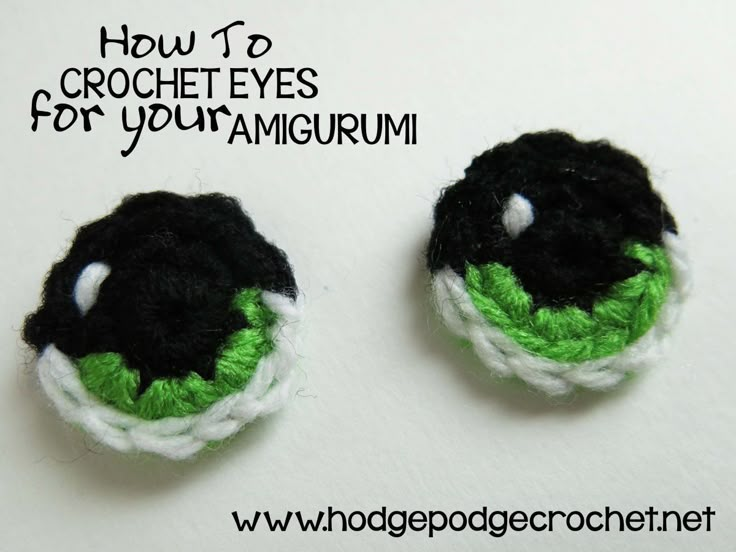 two black and green crocheted buttons on white surface