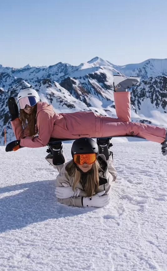 a snowboarder is upside down in the snow