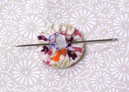 a pinwheel with flowers on it sitting on top of a white cloth covered table