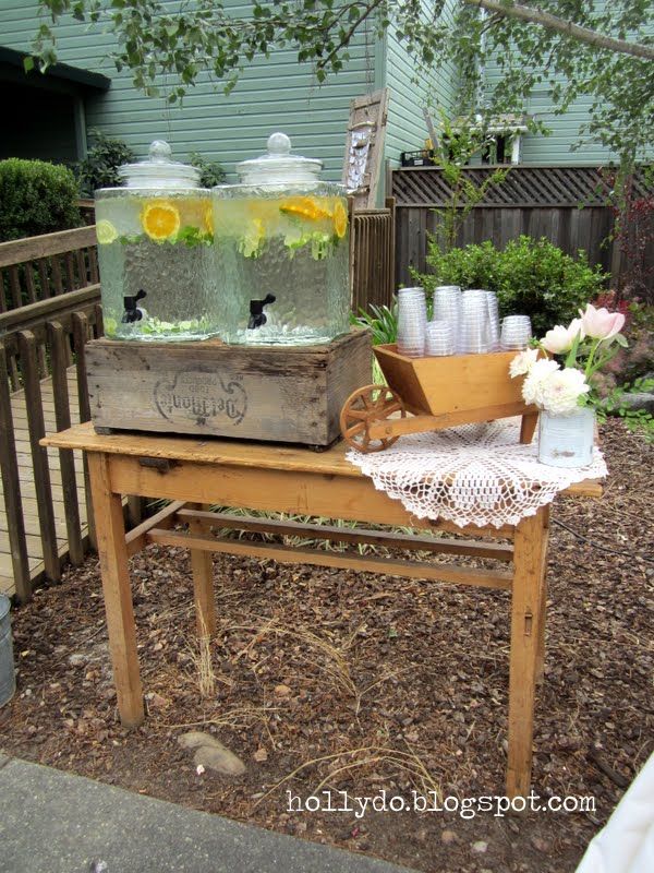 a wooden table topped with jars filled with flowers