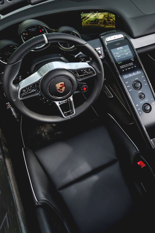 the interior of a sports car with an electronic touch screen and steering wheel controls,