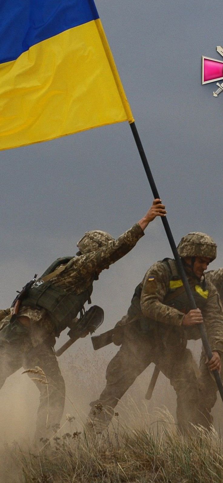 soldiers with flags run through the sand