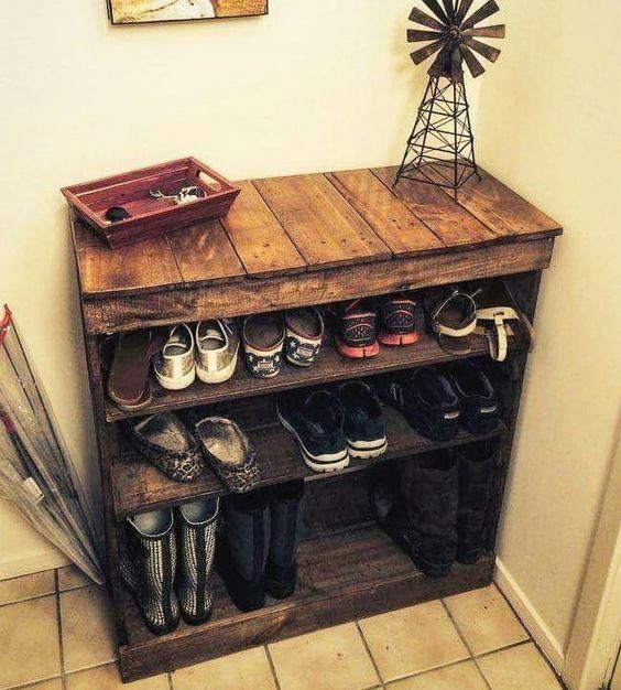 a wooden shelf filled with shoes next to a windmill on top of a tiled floor