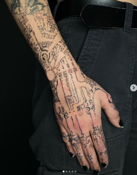 a woman's hand with tattoos on it