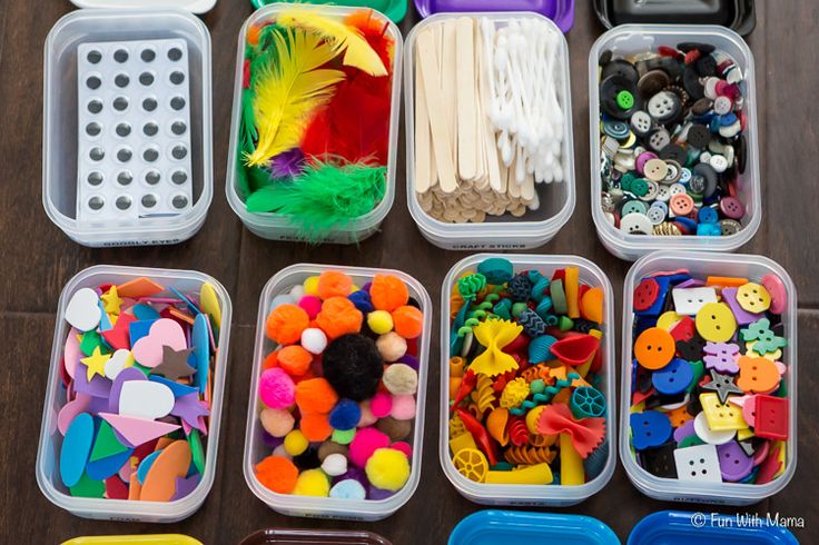 several plastic containers filled with lots of different types of buttons and other crafting supplies