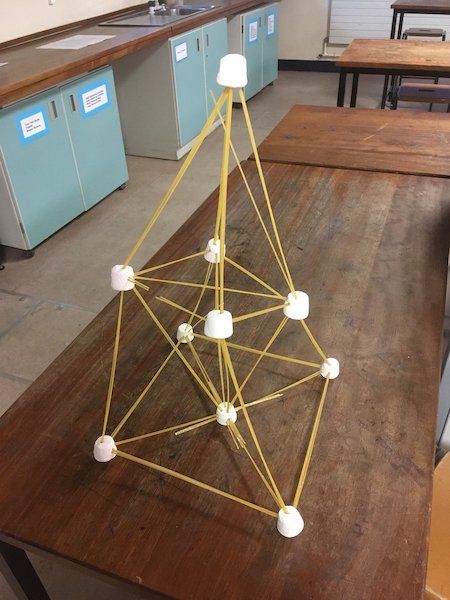 a wooden table topped with a model of a ferris wheel