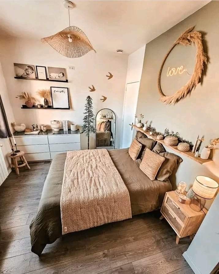 a bed room with a neatly made bed and lots of decorations on the wall above it