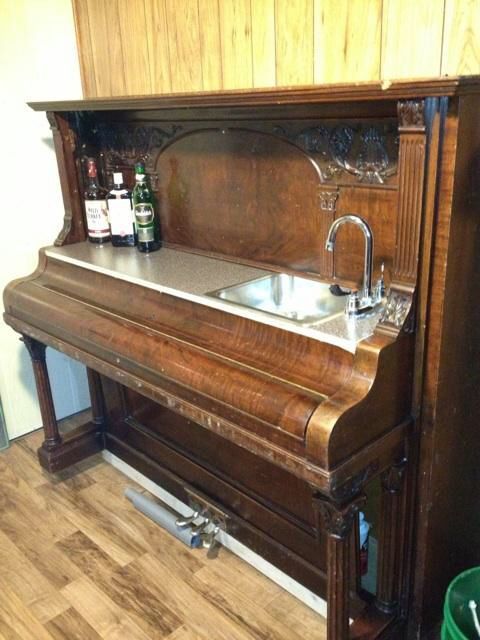 an old piano is being used as a sink