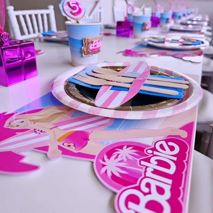 a table set up for a barbie birthday party