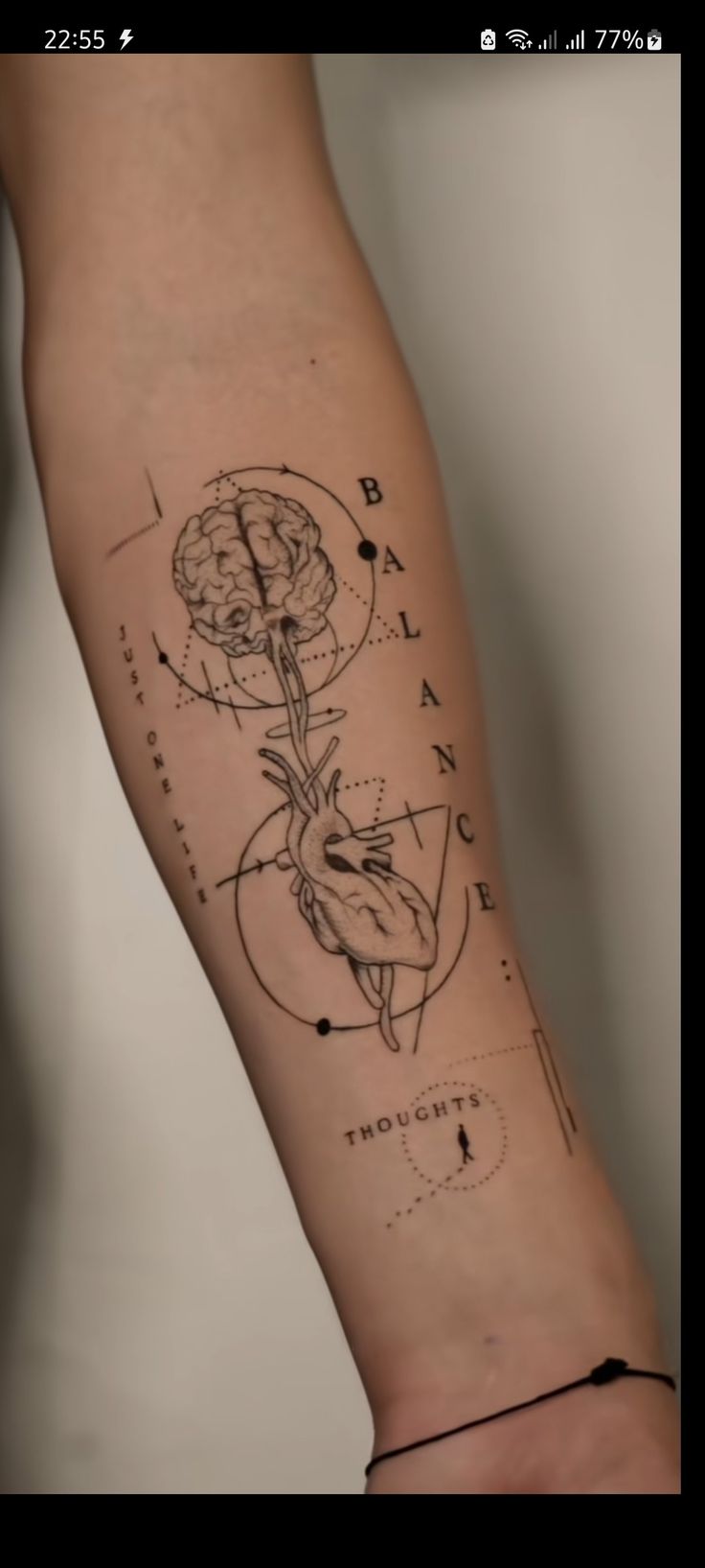 a person's arm with a drawing on it and an arrow in the middle