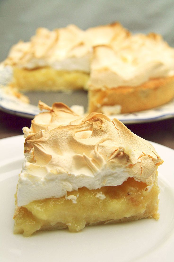 a piece of pie sitting on top of a white plate next to another slice of pie