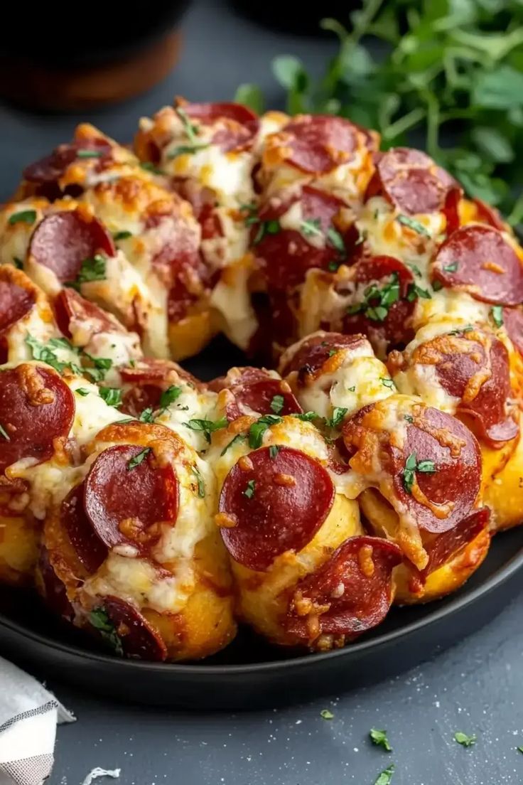 a pepperoni pizza bundt cake on a black plate