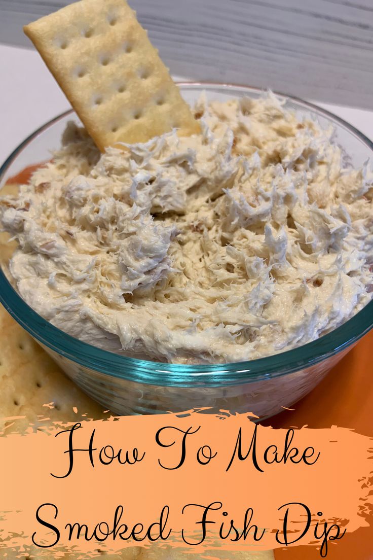 a bowl of smoked fish dip with crackers in it and the words smoked fish dip