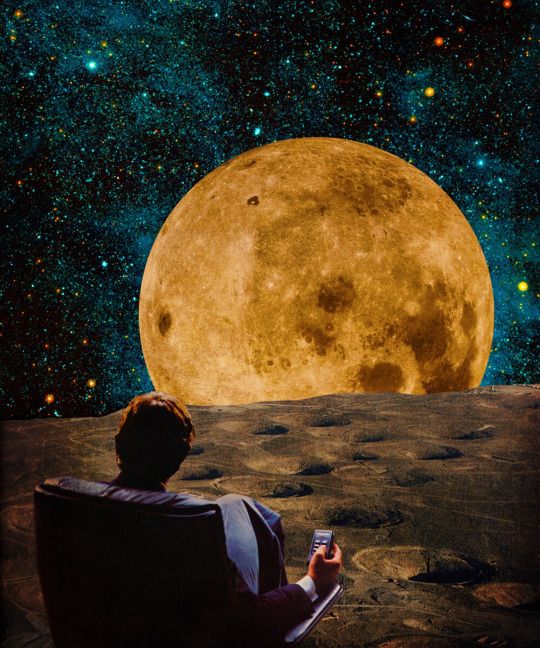 a man sitting on top of a rock next to a giant moon