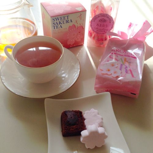 a cup of tea and some treats on a table