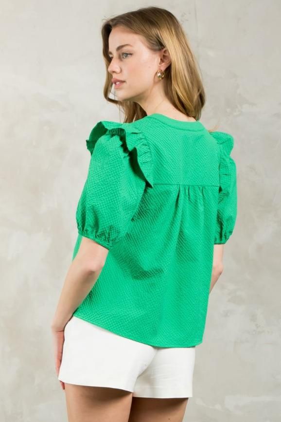 Introducing the Puff Sleeve Textured V-Neck Top in a vibrant green hue. This lightweight blouse features a split neckline and ruffle detail at the shoulder for a touch of playfulness. Its boxy fit makes it easy to tuck into your favorite trousers or pair with flare jeans. Trendy Green Cotton Puff Sleeve Top, Chic Green Puff Sleeve Top, Casual Green Puff Sleeve Tops, Green V-neck Top With Ruffles, Casual Green Puff Sleeve Top For Summer, Green Puff Sleeve Top With Ruffles, Green Puff Sleeve Tops With Ruffles, Green Puff Sleeve Blouse For Summer, Green Puff Sleeve Blouse With Ruffles