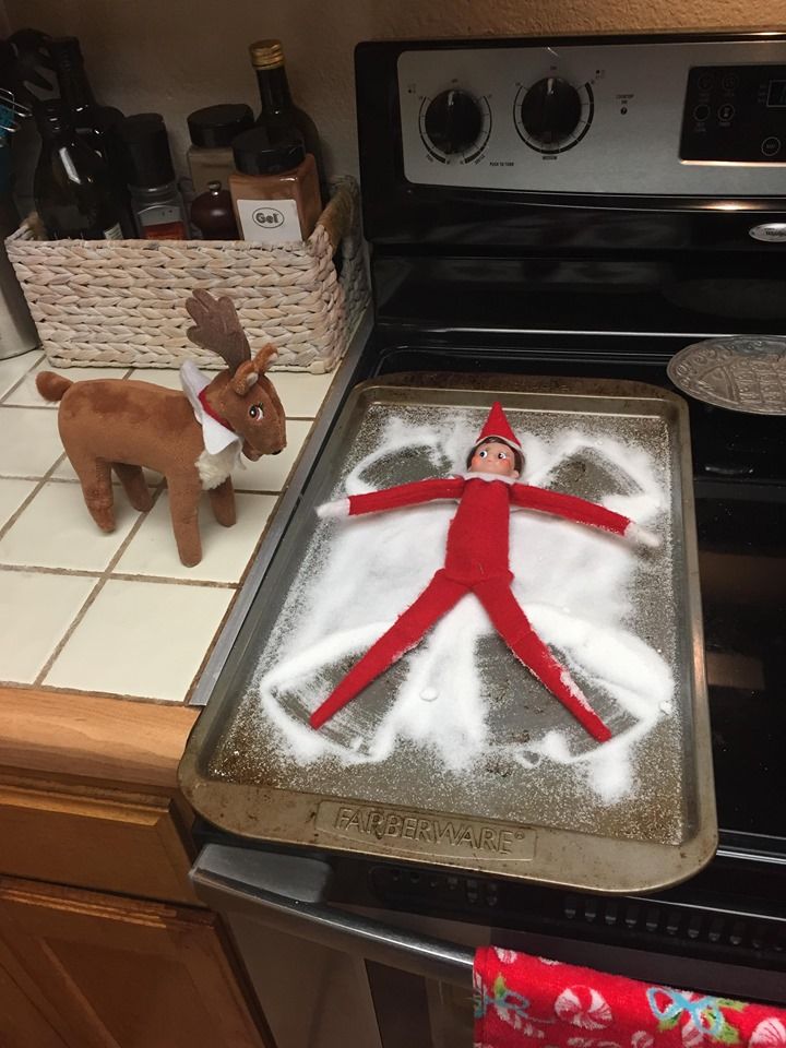 an elf is on top of a sheet cake in the kitchen