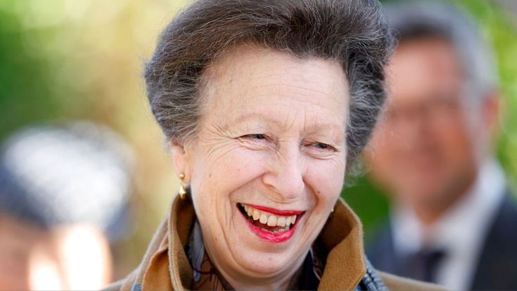 an older woman with grey hair smiling at the camera