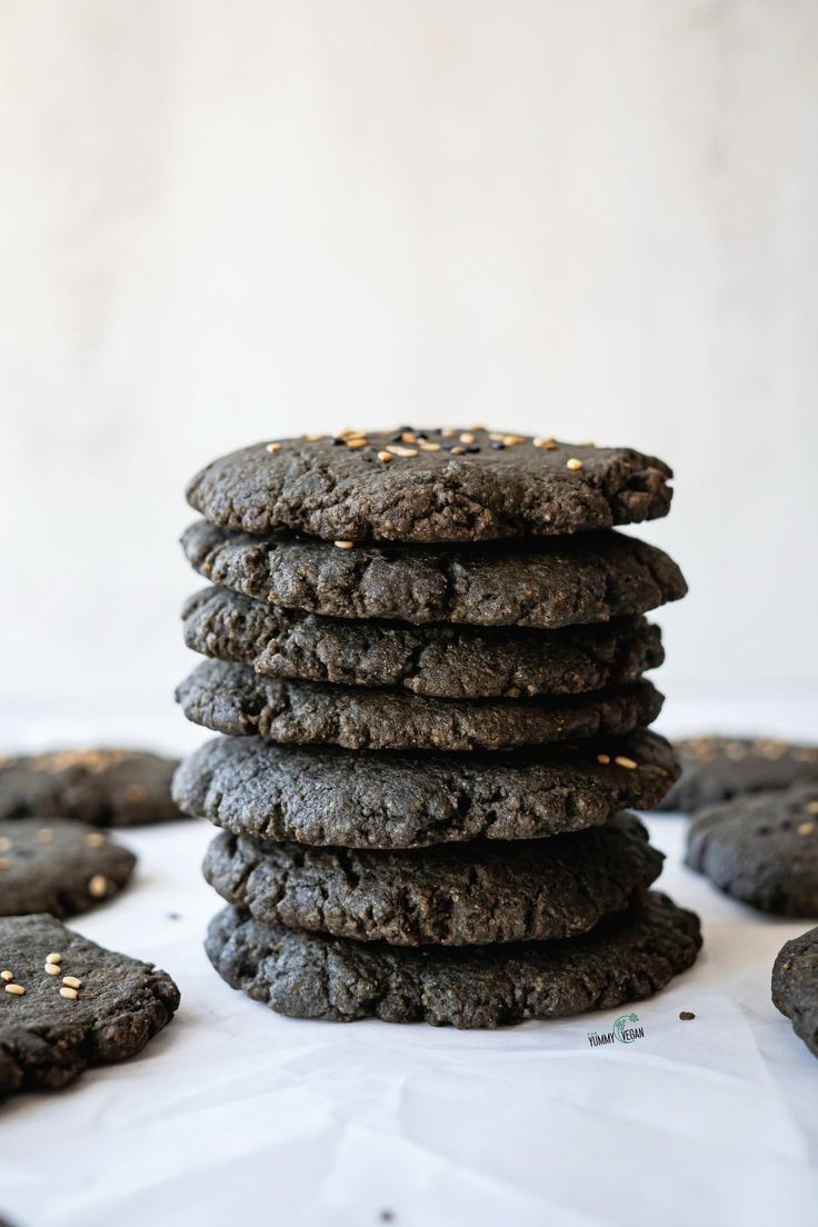 a stack of chocolate cookies sitting on top of a white table next to each other