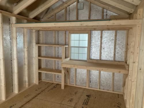 an unfinished room with shelves and windows in it