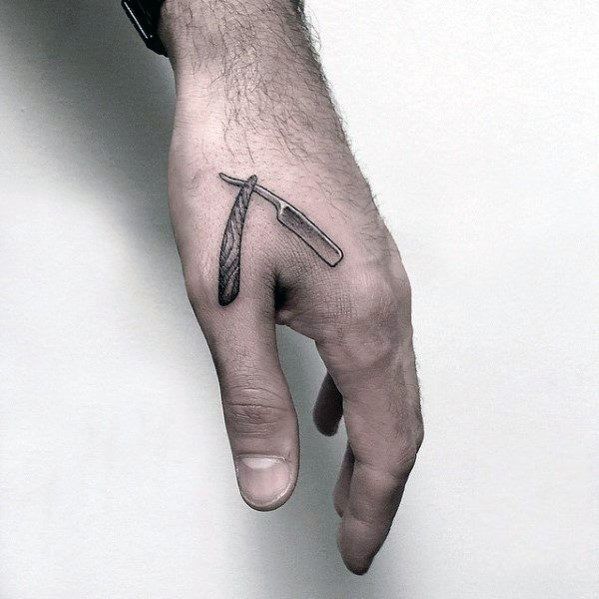 a man's hand with a knife tattoo on it