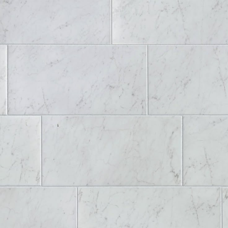 a white marble tile wall that looks like it has been cleaned