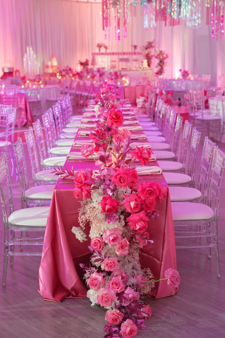 the tables are set with pink and white flowers