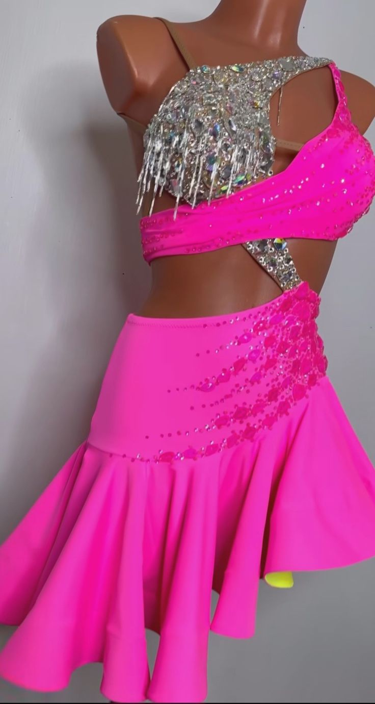 a pink skirt with silver sequins on the top and bottom is shown in front of a mannequin