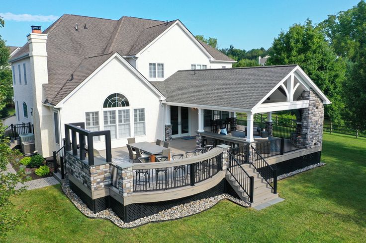 an aerial view of a house with patio and deck