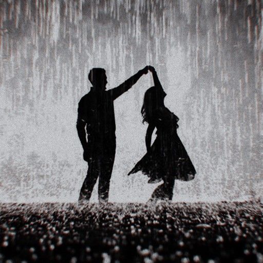 two people dancing in the rain with an umbrella over their heads and one person holding his hand