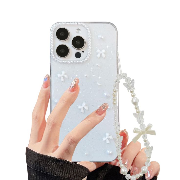 a woman's hand holding an iphone case with white flowers and pearls on it