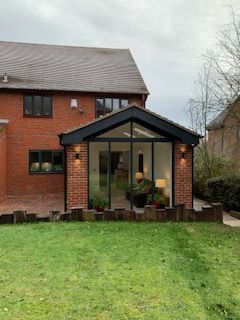 a large brick house with an enclosed patio