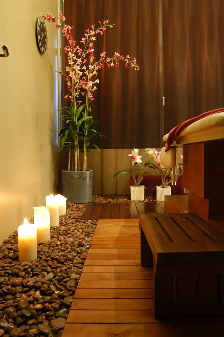 a wooden bench sitting next to a wall with candles on it