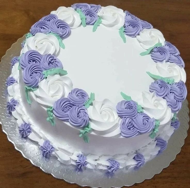 a white and purple cake with flowers on it