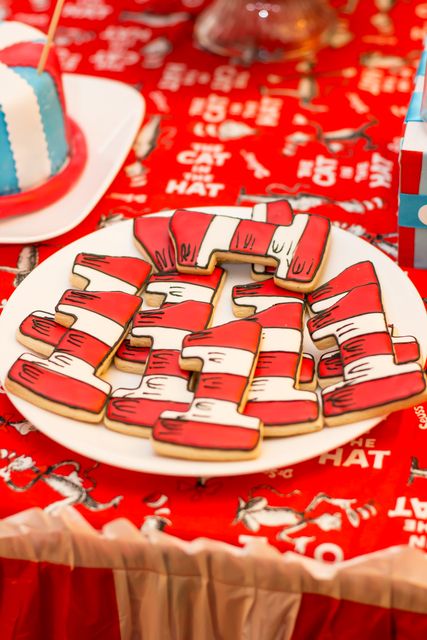 red and white table cloth with cookies on it at a children's birthday party