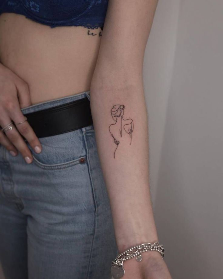 a woman with a small tattoo on her arm